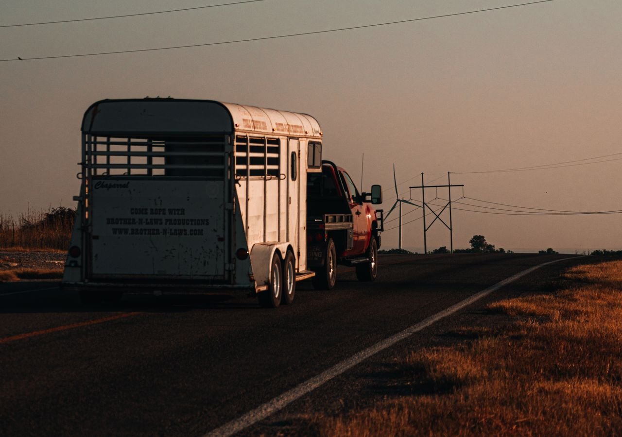 Truck pulling a gooseneck flatbed trailer (hotshot)